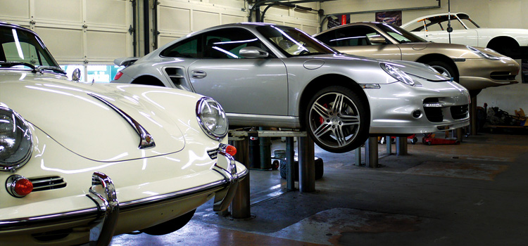 An image of four Porsches inside the shop